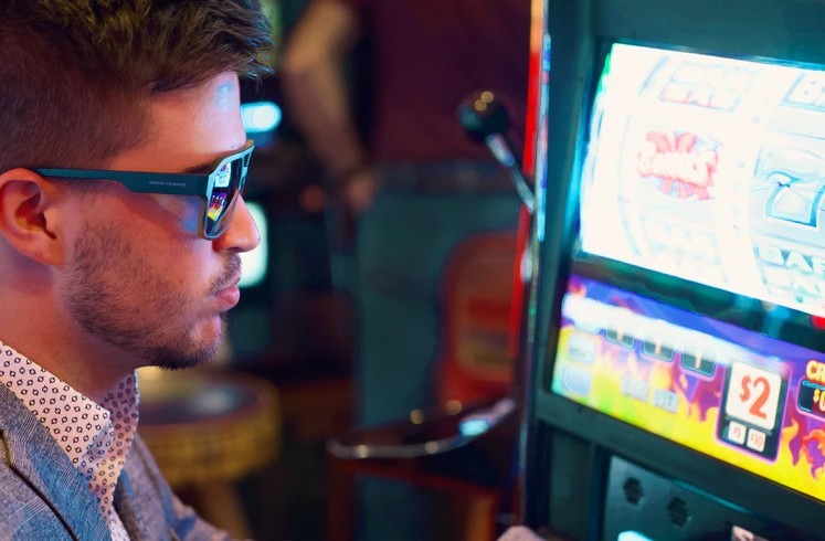man playing on a slot machine