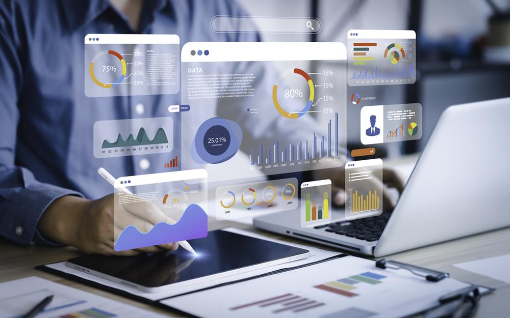 An analyst uses a computer and dashboard for data business analysis