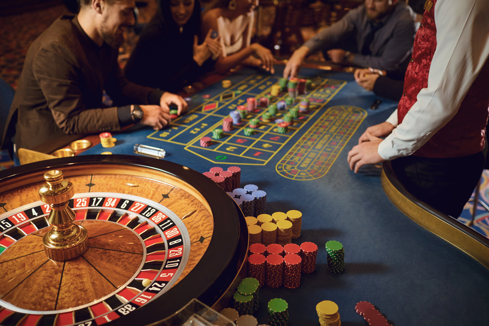 Hand of a croupier on a roulette wheel in a casino