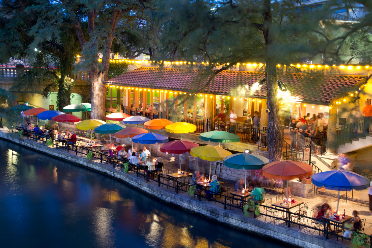 Tourists dining along the San Antonio River Walk in San Antonio, Texas